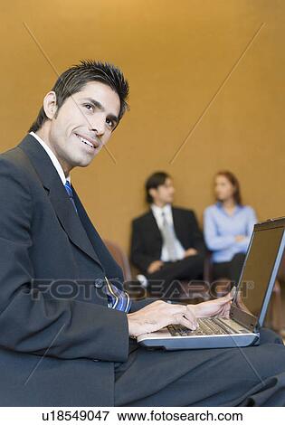 Side profile of a businessman using a laptop View Large Photo Image Stock Photo - Side profile of a businessman using a laptop. Fotosearch