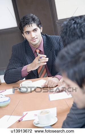 Three business executives discussing in a conference room View Large Photo Image Stock Image - Three business executives discussing in a conference room. Fotosearch