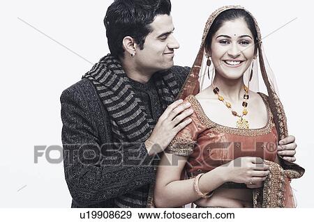 Stock Photo - Close-up of a groom standing behind his bride. Fotosearch