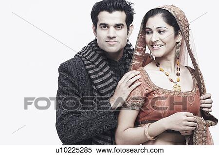 Close-up of a groom standing behind his bride View Large Photo Image Stock Photography - Close-up of a groom standing behind his bride. Fotosearch