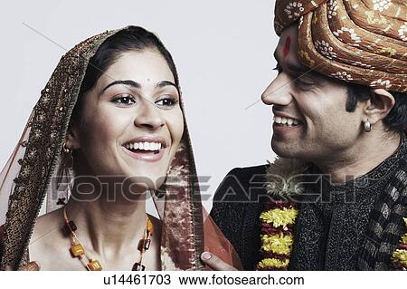 Stock Image - Close-up of a newlywed couple smiling. Fotosearch