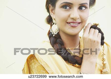Close-up of a young woman smiling View Large Photo Image Stock Photo - Close-up of a young woman smiling. Fotosearch