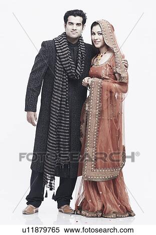 Newlywed couple standing with their arms around each other View Large Photo Image Stock Photography - Newlywed couple standing with their arms around each other. Fotosearch
