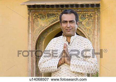Portrait of a mid adult man greeting, Neemrana Fort Palace, Neemrana, Alwar, Rajasthan, India View Large Photo Image Stock Photo - Portrait of a mid adult man greeting, Neemrana Fort Palace, Neemrana, Alwar, Rajasthan, India. Fotosearch