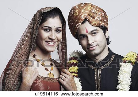 Stock Photograph - Portrait of a newlywed couple smiling. Fotosearch