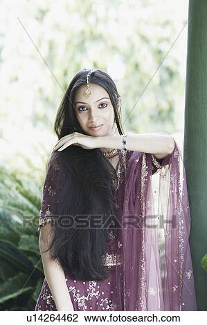 Portrait of a teenage girl posing in a traditional dress View Large Photo Image Stock Image - Portrait of a teenage girl posing in a traditional dress. Fotosearch