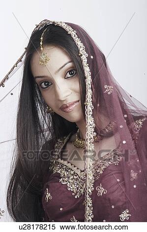Stock Photography - Portrait of a teenage girl posing in a traditional dress. Fotosearch
