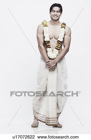 Portrait of a young man in traditional clothing wearing a garland View Large Photo Image Stock Image - Portrait of a young man in traditional clothing wearing a garland. Fotosearch