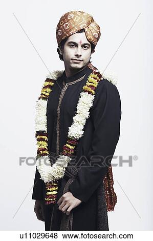 Portrait of a young man wearing a traditional wedding outfit View Large Photo Image Stock Photo - Portrait of a young man wearing a traditional wedding outfit. Fotosearch
