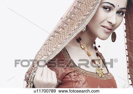 Portrait of a young woman in traditional clothing smiling View Large Photo Image Stock Photo - Portrait of a young woman in traditional clothing smiling. Fotosearch