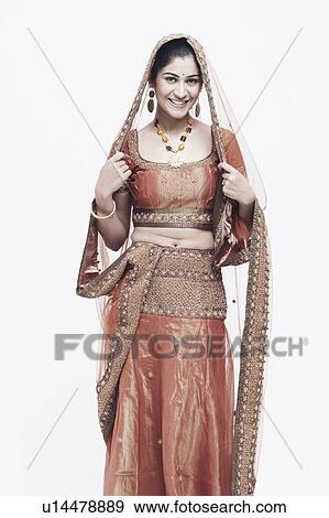 Stock Photo - Portrait of a young woman in traditional clothing smiling. Fotosearch
