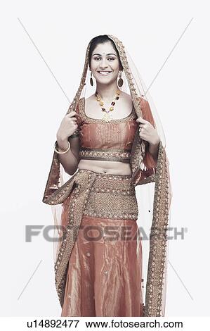 Portrait of a young woman in traditional clothing smiling View Large Photo Image Stock Photo - Portrait of a young woman in traditional clothing smiling. Fotosearch