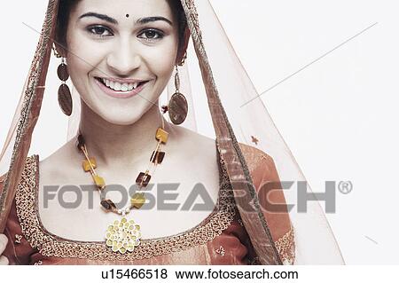 Portrait of a young woman in traditional clothing smiling View Large Photo Image Stock Photo - Portrait of a young woman in traditional clothing smiling. Fotosearch