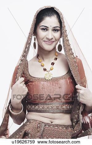 Stock Photo - Portrait of a young woman in traditional clothing smiling. Fotosearch