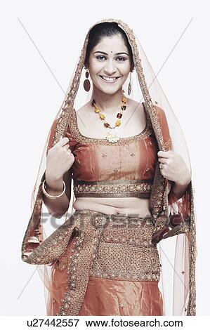 Stock Photo - Portrait of a young woman in traditional clothing smiling. Fotosearch
