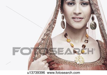 Stock Photograph - Portrait of a young woman in traditional clothing smiling. Fotosearch