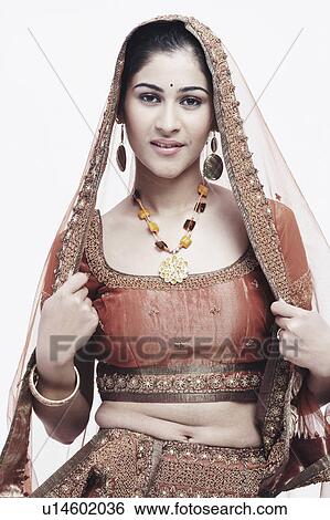Stock Photograph - Portrait of a young woman in traditional clothing smiling. Fotosearch