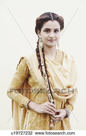 Stock Image - Portrait of a young woman standing. Fotosearch