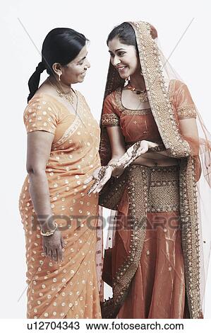 Stock Image - Side profile of a mother and her daughter. Fotosearch