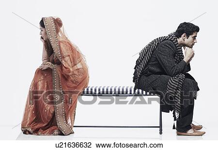 Side profile of a newlywed couple sitting on opposite ends of a bench View Large Photo Image Stock Image - Side profile of a newlywed couple sitting on opposite ends of a bench. Fotosearch