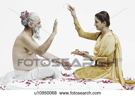 Side profile of a priest blessing a young woman View Large Photo Image Stock Photo - Side profile of a priest blessing a young woman. Fotosearch
