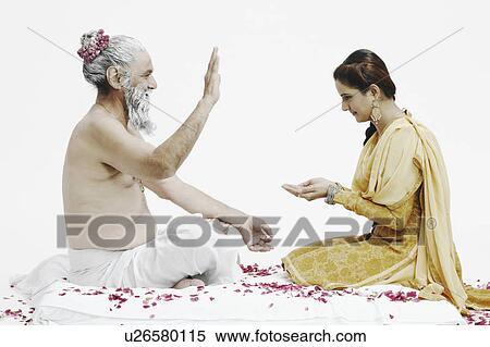 Stock Photography - Side profile of a priest blessing a young woman. Fotosearch