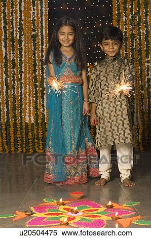 Boy and his sister holding sparklers View Large Photo Image Stock Photography - Boy and his sister holding sparklers. Fotosearch