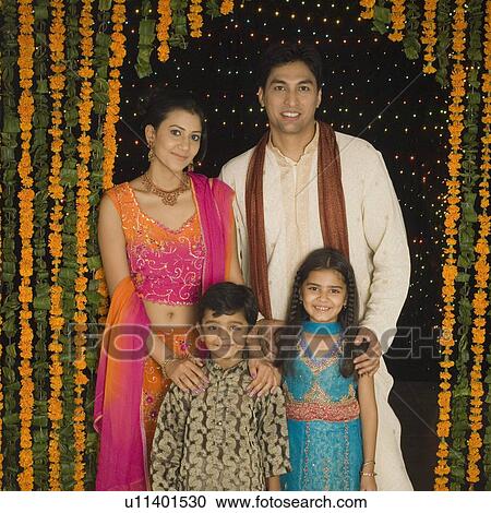 Portrait of a young couple and their two children standing at the entrance View Large Photo Image Stock Image - Portrait of a young couple and their two children standing at the entrance. Fotosearch