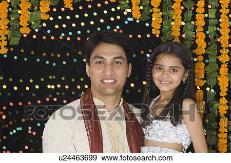 Portrait of a young man carrying his daughter and smiling View Large Photo Image Stock Photo - Portrait of a young man carrying his daughter and smiling. Fotosearch