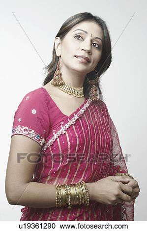 Stock Image - Close-up of a mid adult woman looking up. Fotosearch