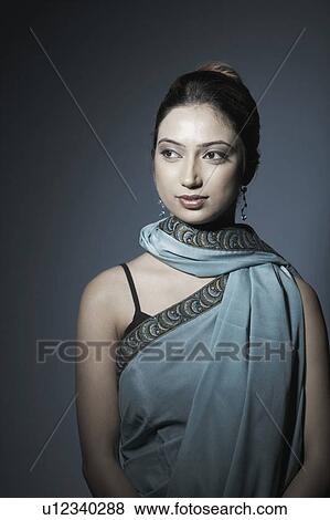 Stock Photo - Close-up of a young woman looking away. Fotosearch