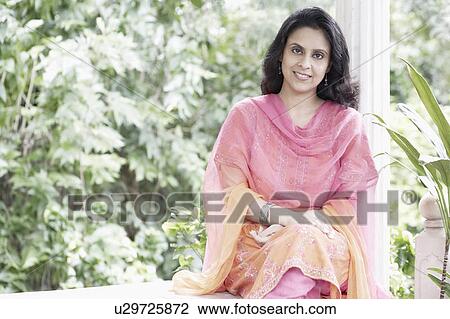 Portrait of a mid adult woman smiling View Large Photo Image Stock Image - Portrait of a mid adult woman smiling. Fotosearch