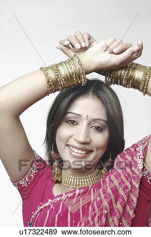 Portrait of a mid adult woman with her hands above her head View Large Photo Image Stock Photo - Portrait of a mid adult woman with her hands above her head. Fotosearch