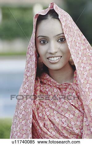 Portrait of a teenage girl covering her head with a sari View Large Photo Image Stock Photography - Portrait of a teenage girl covering her head with a sari. Fotosearch
