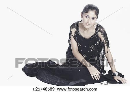 Stock Photo - Portrait of a young woman sitting. Fotosearch