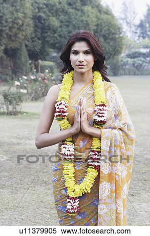 Portrait of a young woman standing in a prayer position View Large Photo Image Stock Photography - Portrait of a young woman standing in a prayer position. Fotosearch