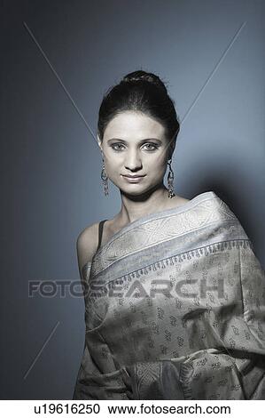 Portrait of a young woman wearing a sari View Large Photo Image Stock Image - Portrait of a young woman wearing a sari. Fotosearch