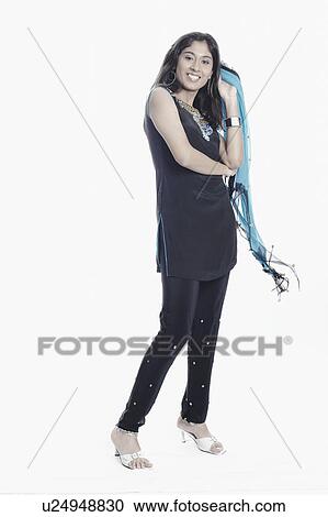Side profile of a young woman holding a stole View Large Photo Image Stock Image - Side profile of a young woman holding a stole. Fotosearch