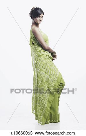 Side profile of a young woman smiling View Large Photo Image Stock Image - Side profile of a young woman smiling. Fotosearch