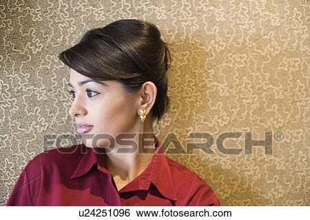 Close-up of a businesswoman leaning against a wall View Large Photo Image Stock Photograph - Close-up of a businesswoman leaning against a wall. Fotosearch