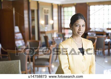 Portrait of a waitress standing in a restaurant View Large Photo Image Stock Image - Portrait of a waitress standing in a restaurant. Fotosearch