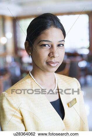 Portrait of a waitress standing in a restaurant View Large Photo Image Stock Image - Portrait of a waitress standing in a restaurant. Fotosearch