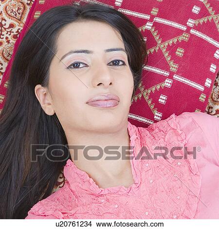 Portrait of a young woman lying down View Large Photo Image Picture - Portrait of a young woman lying down. Fotosearch