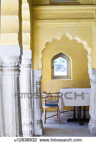 Stock Image - Chair and a table at a palace, Neemrana Fort Palace, Neemrana, Alwar, Rajasthan, India. Fotosearch