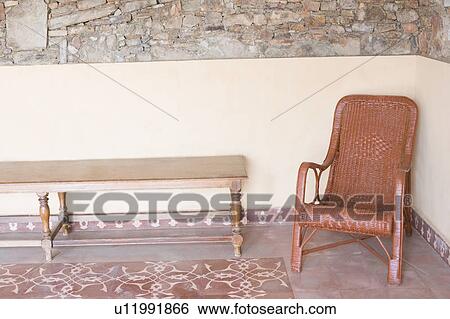 Chair and a table in a living room View Large Photo Image Stock Photograph - Chair and a table in a living room. Fotosearch
