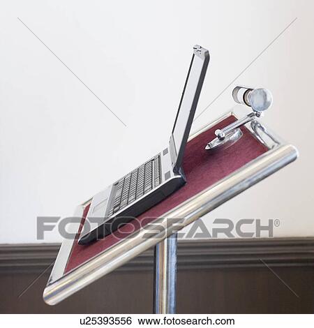 Stock Photograph - Close-up of an open laptop on a lectern. Fotosearch