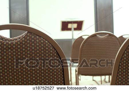Close-up of empty chairs in a conference room View Large Photo Image Stock Photo - Close-up of empty chairs in a conference room. Fotosearch