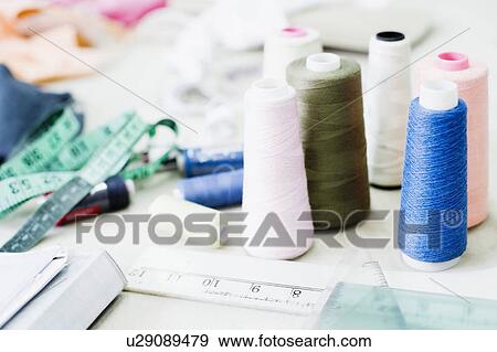 Close-up of spools of thread with a tape measure View Large Photo Image Stock Photo - Close-up of spools of thread with a tape measure. Fotosearch