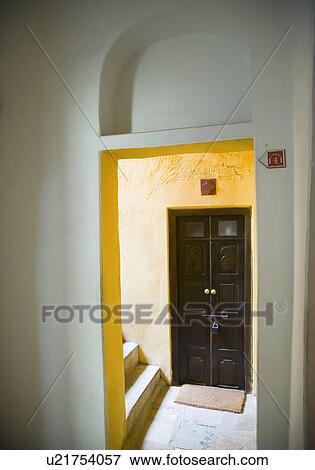 Stock Photo - Closed door viewed through an entrance. Fotosearch