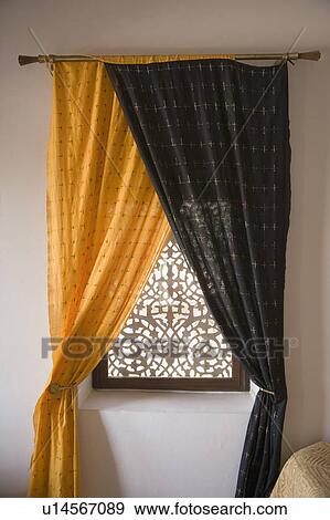 Stock Photo - Curtains hanging on a window in a hotel room. Fotosearch